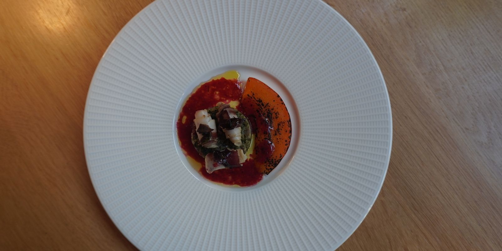 Restaurant Wannee: pumpkin dish with caramelized seeds, fermented plum, kombucha dressing, and dry-aged bacon.