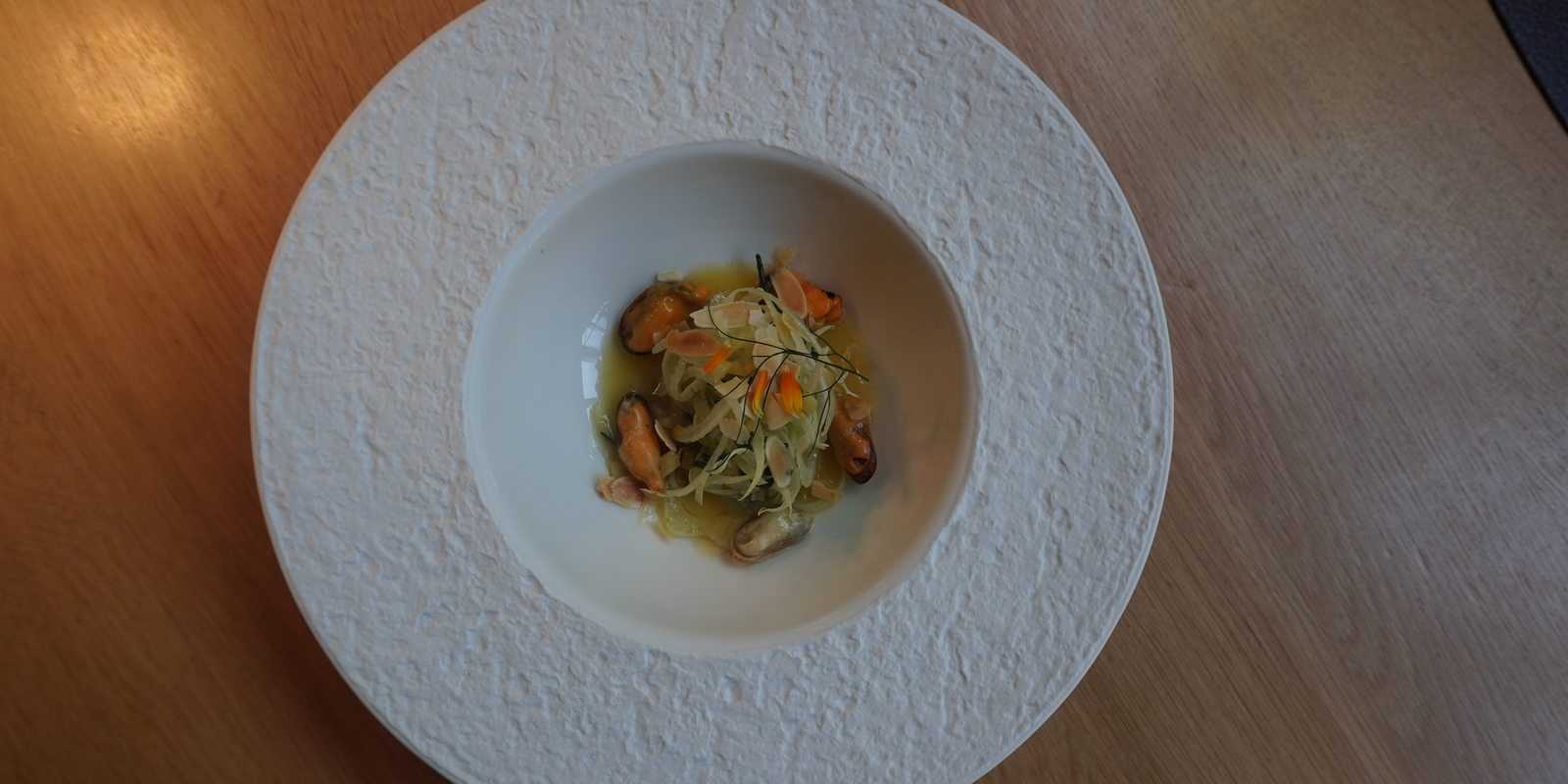 Restaurant Wannee: fennel dish with mussels, almond flakes, beurre noisette, and marigold.